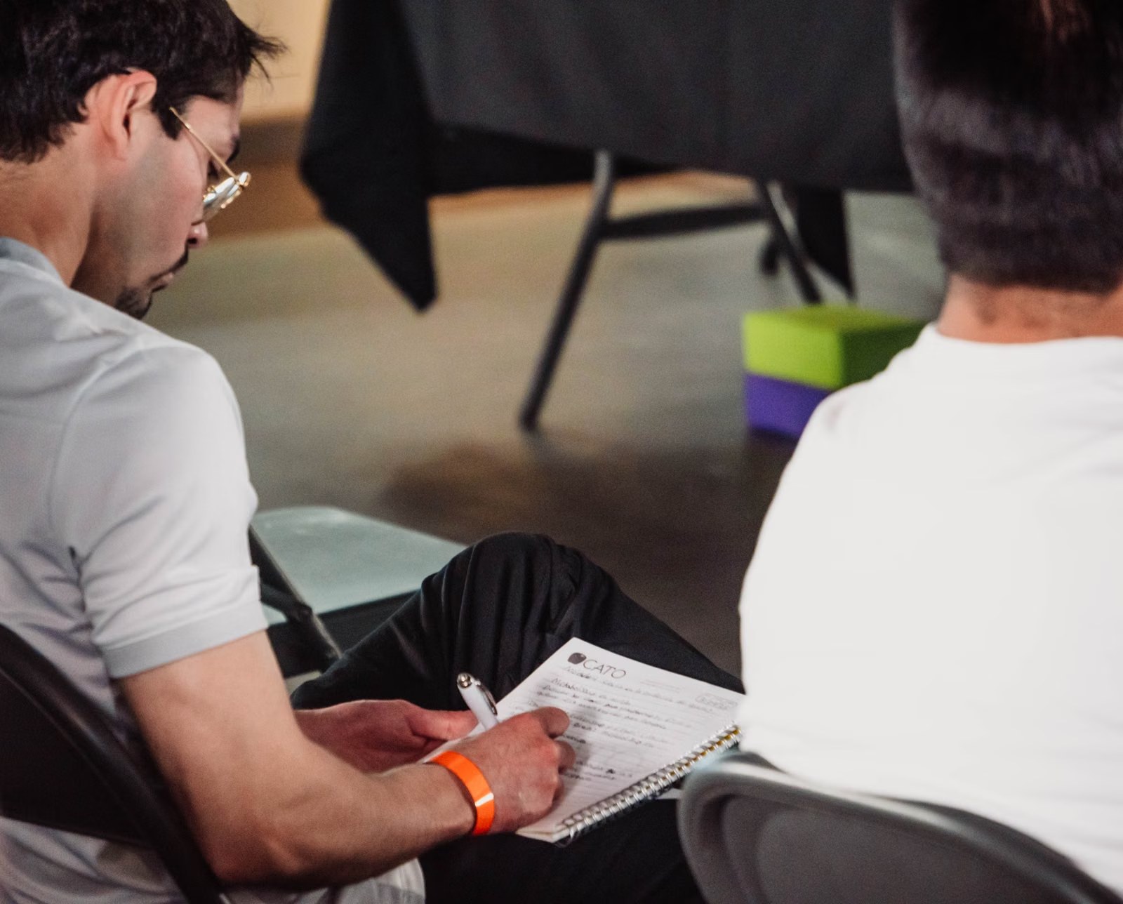 A professional taking notes during an interactive session