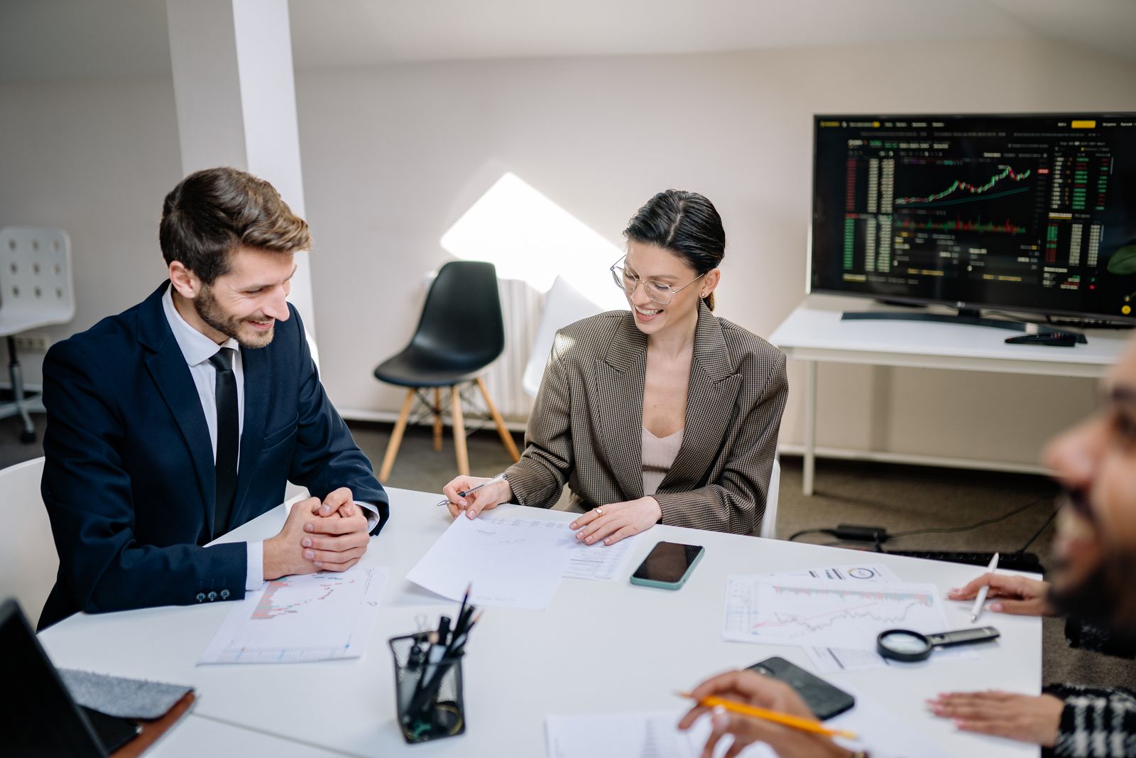 Financial professionals analyzing market data on screens
