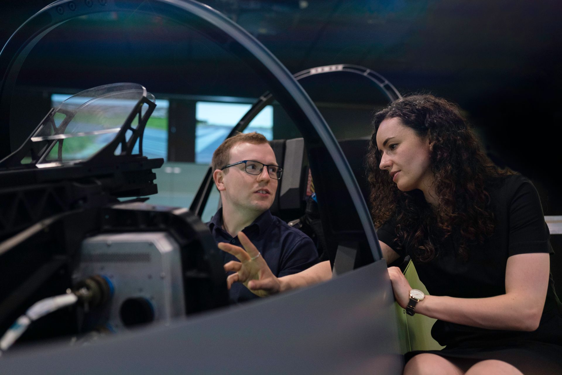 Engineers analyzing aircraft cockpit design during a simulation session