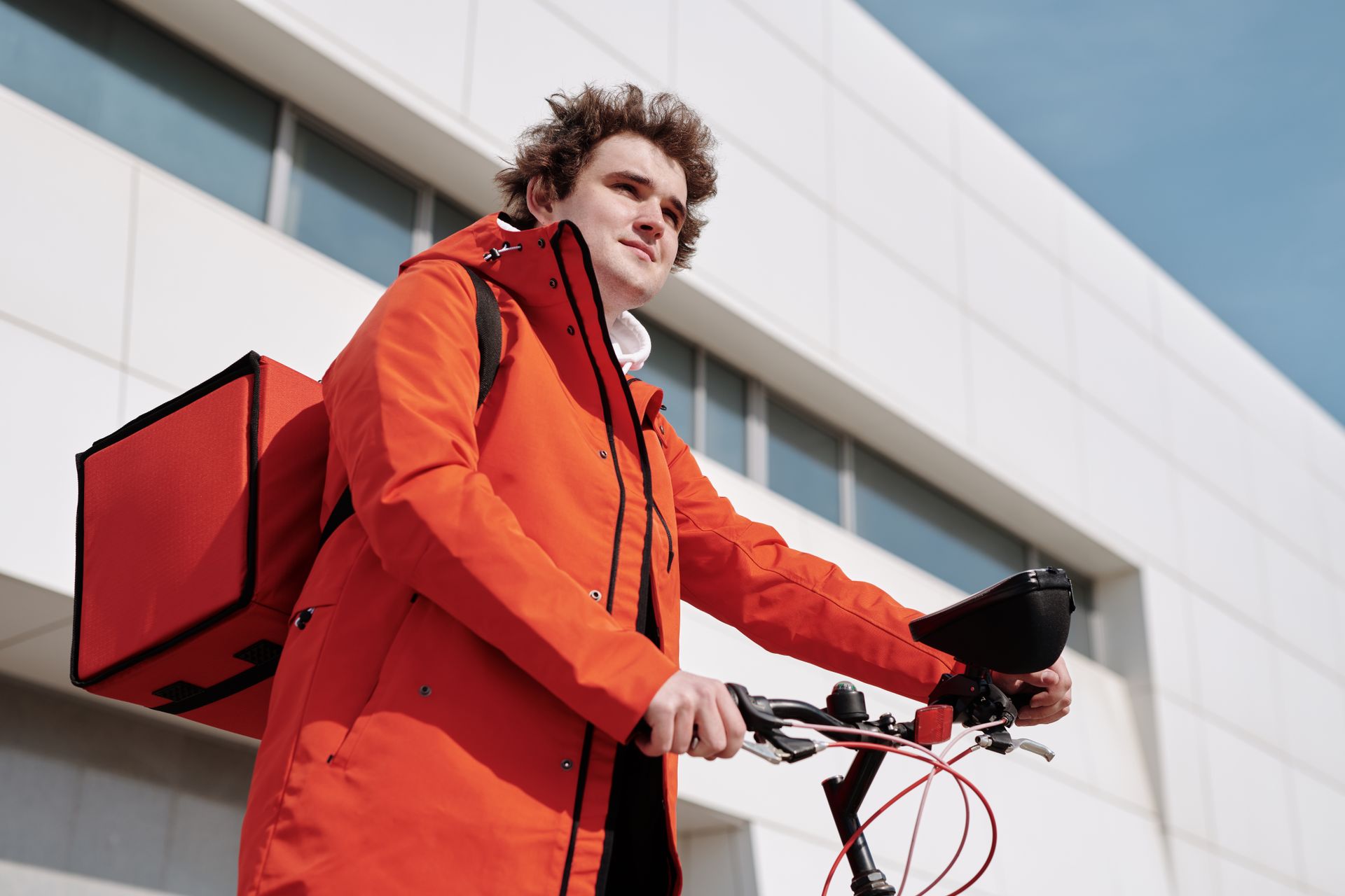 A delivery cyclist with a thermal bag riding through the city