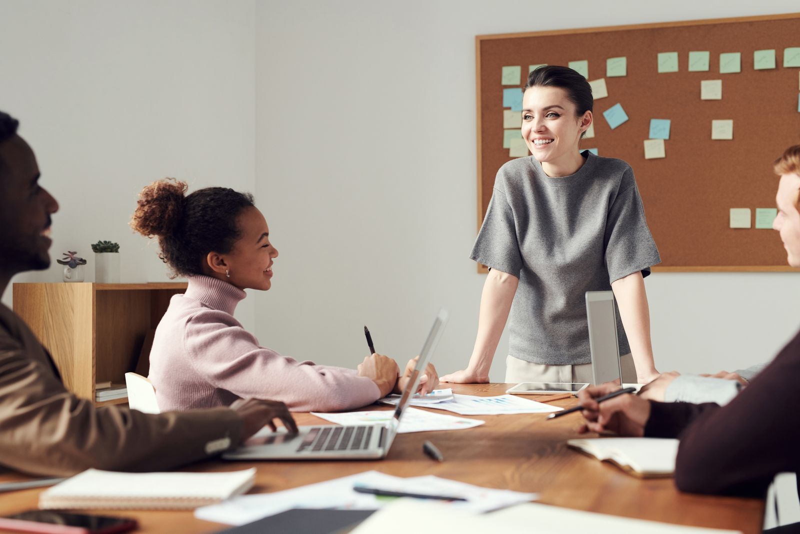 A supervisor training her production team around a table