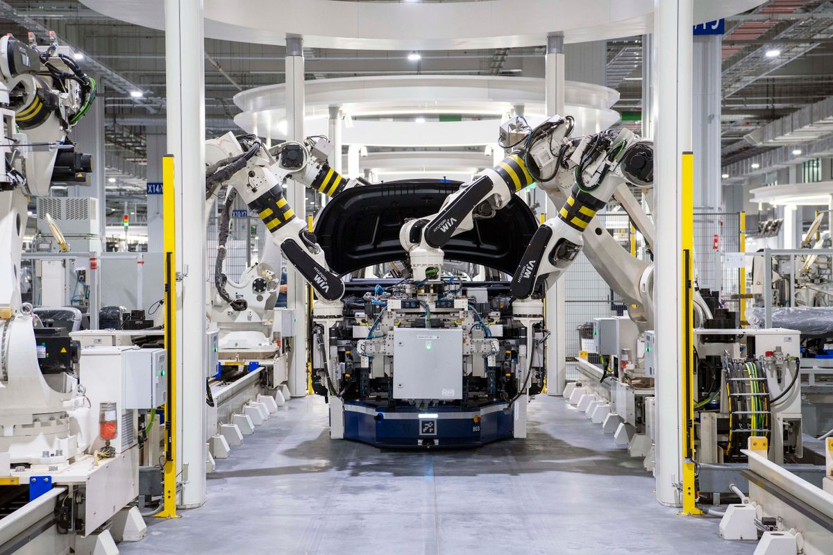 An engineer reviewing EV powertrain diagnostics with a colleague