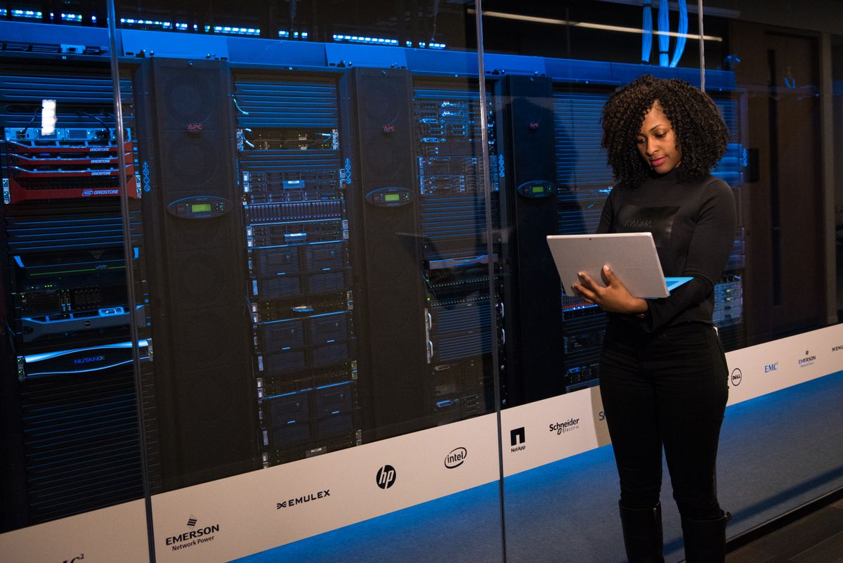 A network engineer planning the next rollout wave with her team