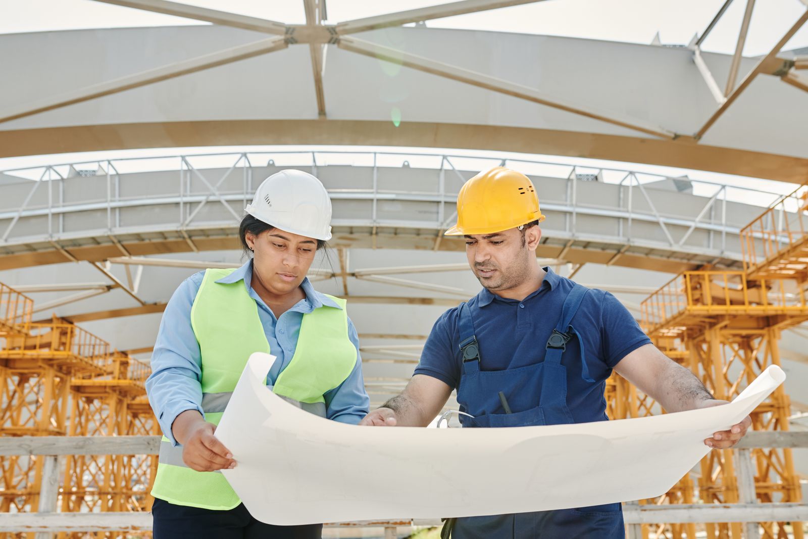 Two engineers reviewing plans on a construction site