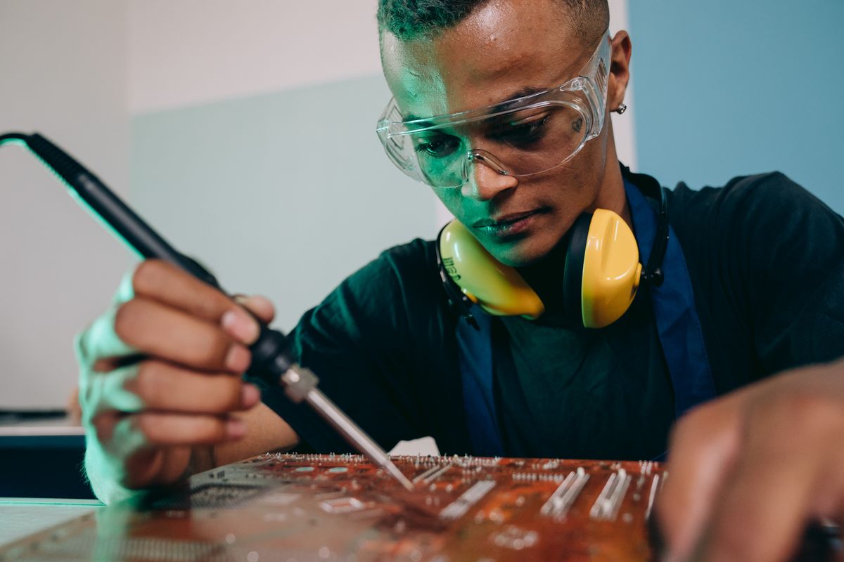 An engineer soldering a circuit board with precision